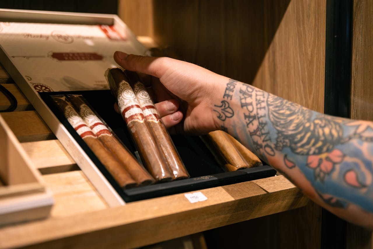 Close-up of handpicking premium cigars for refined lifestyle